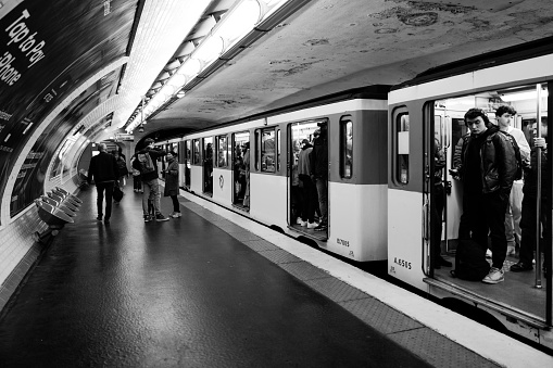 Paris, France - April 9th, 2024: Subway station tourists taking public transport metro in Paris