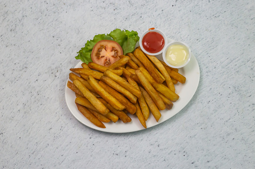 French fries with mayo dip and tomato ketchup sauce served in dish isolated on grey background top view of bangladeshi fastfood