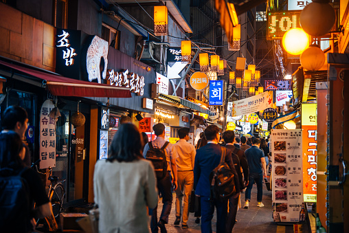 People walk along the evening streets in the centre of Seoul, South Korea.