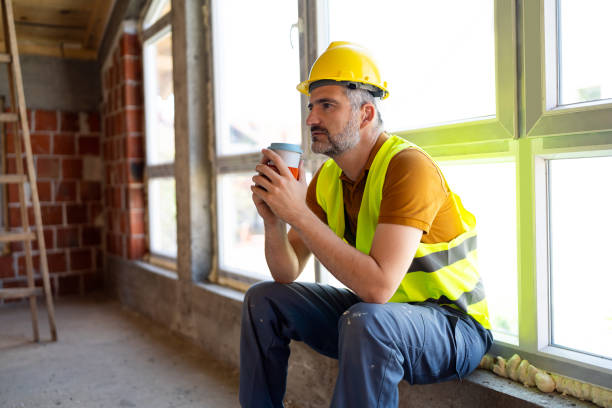 istock Tired mid-adult Caucasian construction worker, on a coffee break at construction site 2148938478