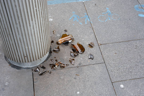 istock Broken glass bottle on a pedestrian walkway 2148938596