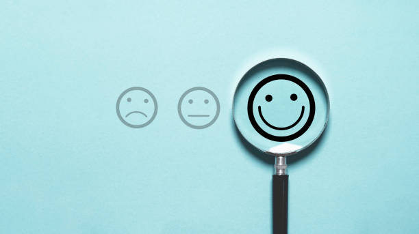 istock Smile face icon inside magnifier glass for customer excellent evaluation and feedback survey after use product and service concept. 2148939261