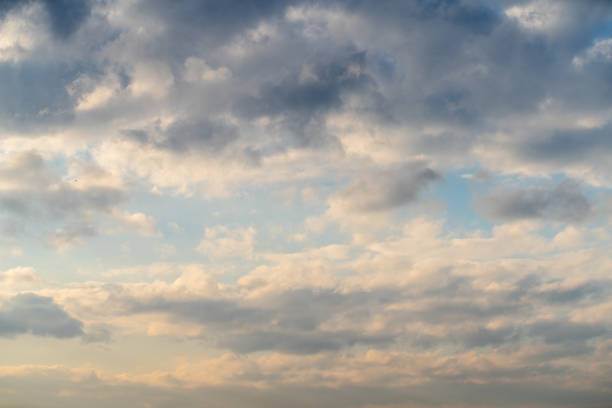 Sunset sky. Majestic overcast clouds in the sky at sunset, calm before storm.