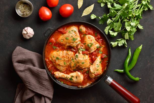 istock Georgian chicken stew with tomatoes and herbs. Top view, flat lay 2148940483