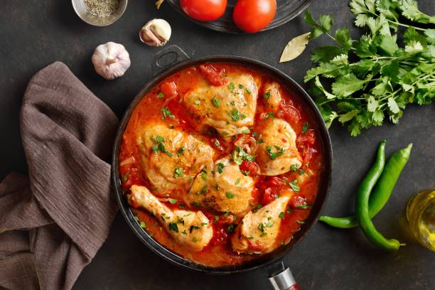 istock Georgian chicken stew with tomatoes and herbs. Top view, flat lay 2148940543