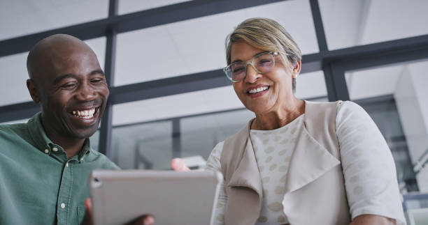 istock Tablet, smile and business people in office for teamwork laughing for comic, funny or comedy meme. Happy, research and creative designers watching goofy video on digital technology in lunch break. 2148941318
