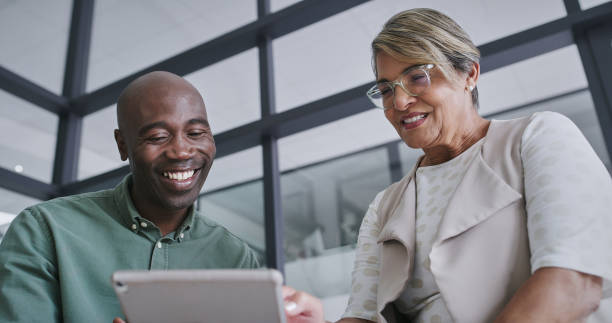 istock Tablet, talking and business people in office for teamwork with research for creative project. Collaboration, plan and designers working on digital technology with partnership in workplace boardroom. 2148941324