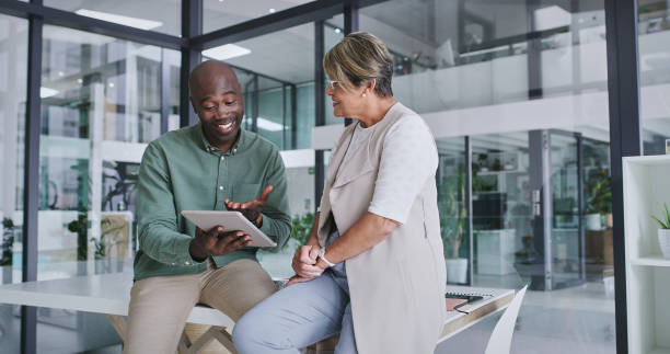 istock Tablet, search and business people in office for training, brainstorming or idea collaboration. Digital agency, support and man with mature woman mentor for coaching, learning or app faq discussion 2148941331
