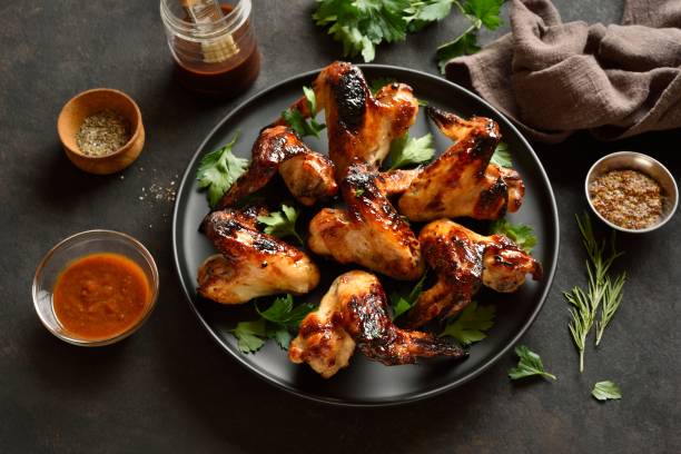 istock Bbq chicken wings on dark stone background. Close up view 2148942495