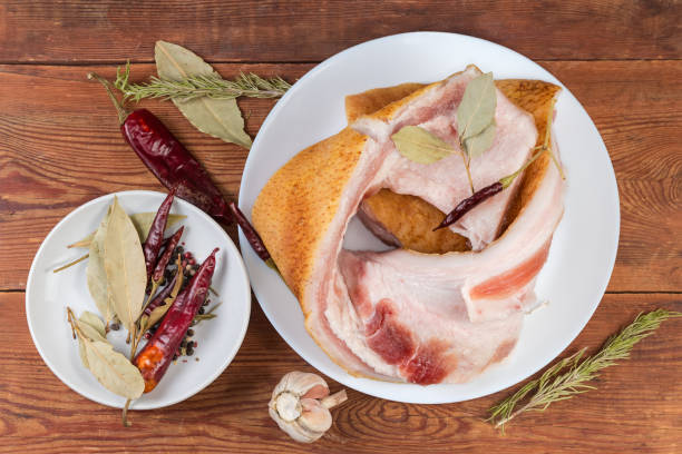istock Salted pork fatback among different dry spices on rustic table 2148942989