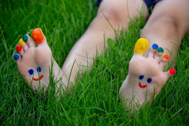a smile drawn with paints on a child's legs.