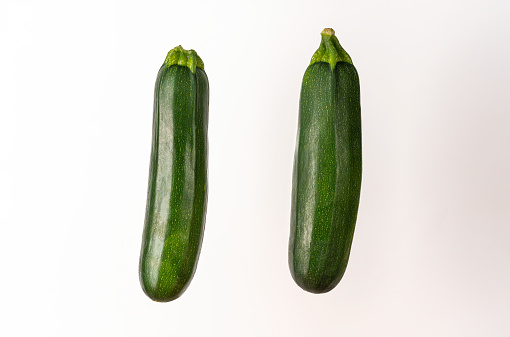 couple of zucchini vertically isolated on white background