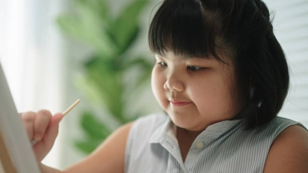 A girl enjoy painting.