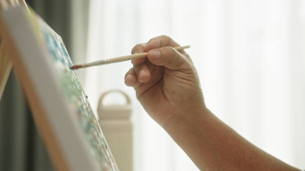 istock Senior woman drawing on canvas. 2148945967