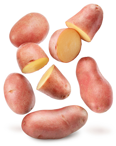 Red skin potatoes falling down on white background. File contains clipping paths.