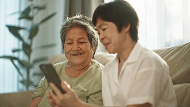 istock Two elderly woman relax watching entertainment on smartphone. 2148946619