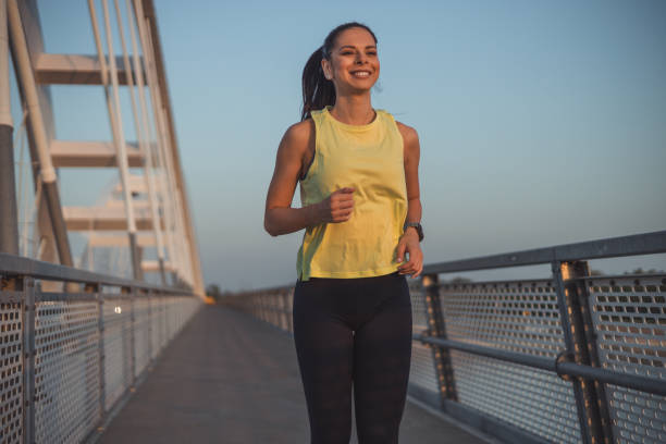 istock Young caucasian woman runner jogging on the bridge 2148946990