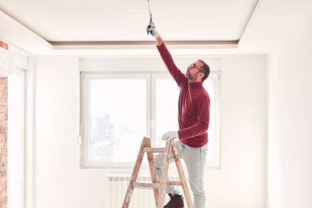 istock Handyman electrician with ladders working in a new home interior. 2148947140
