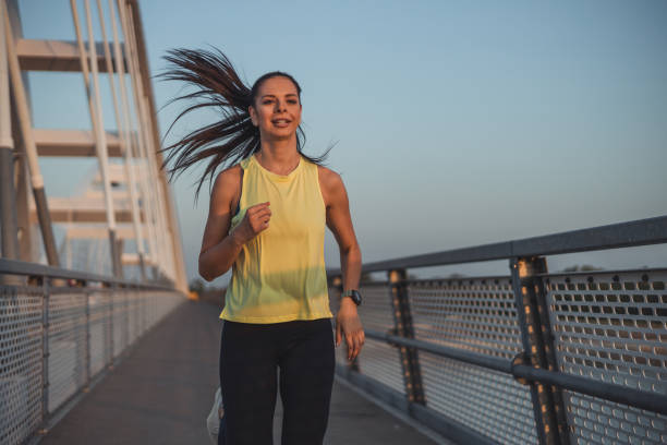 istock Young caucasian woman runner jogging on the bridge 2148947365
