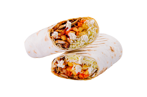 Close-up of a delicious vegetarian wrap sliced in half, isolated on a white background