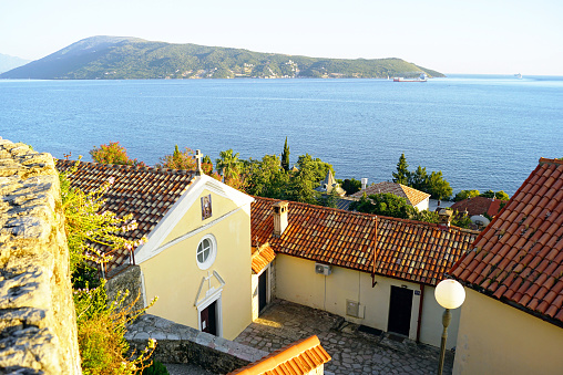 Buildings in the Old Town of Herceg Novi against the backdrop of the Bay of Kotor and the Adriatic Sea