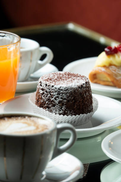 Chocolate cake with cappuccino and freshly squeezed juice