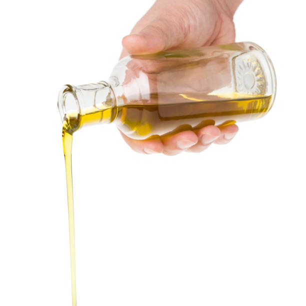 istock Oil pouring from a bottle. 2148948631