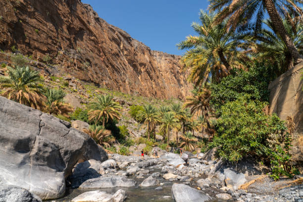 istock Tourists hiking in Wadi Al Nakhr under Jebel Shams, Oman 2148948708
