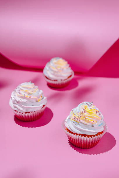 istock Colorful cupcakes on pink background 2148948734