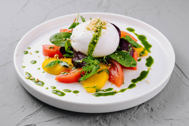 istock Fresh caprese salad with pesto drizzle on plate 2148948903