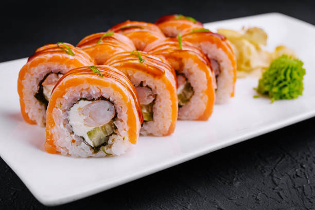 istock Delicious salmon sushi roll on white plate 2148949330