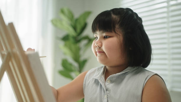 istock A girl enjoy painting. 2148949628