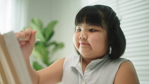 istock A girl enjoy painting. 2148949631