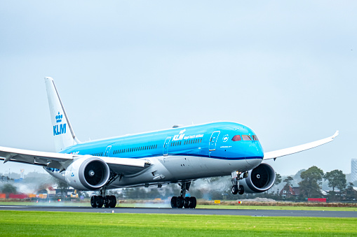 KLM Boeing 787 Dreamliner airplane landing at Schiphol airport on the Polderbaan. KLM stands for Koninklijke Luchtvaart Maatschappij,  Royal Dutch Airlines and is part of Air France–KLM. The Boeing 787 alos called Dreamliner is a wide-body jet airliner by American manufacturer Boeing Commercial Airplanes. Schiphol is one of the busiest and largest airports in Europe, located near Amsterdam, Netherlands. It serves as a major hub for international flights and is a key gateway to Europe.