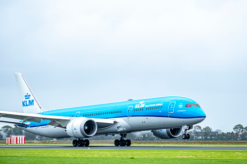 KLM Boeing 787 Dreamliner airplane landing at Schiphol airport on the Polderbaan. KLM stands for Koninklijke Luchtvaart Maatschappij,  Royal Dutch Airlines and is part of Air France–KLM. The Boeing 787 alos called Dreamliner is a wide-body jet airliner by American manufacturer Boeing Commercial Airplanes. Schiphol is one of the busiest and largest airports in Europe, located near Amsterdam, Netherlands. It serves as a major hub for international flights and is a key gateway to Europe.