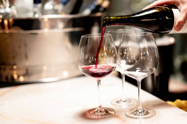 istock Pouring  redcwine at luxury restaurant and luxuryy tabel settings 2148950766
