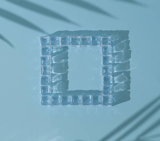 istock Summer sunlight composition with ice cubes and tropical palm leaves shadow on blue color background. Minimal summertime drink concept. Creative copy space. Flat lay, top of view. 2148951366