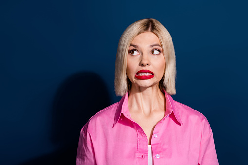 Photo of frightened horrified nice woman with bob hairstyle dressed pink shirt staring at empty space isolated on dark blue background.