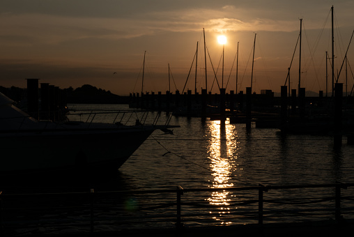 Sunsets at the marina are picturesque. The light of the setting sun reflecting off the quiet surface of the sea paints the surface of the water with the shadows of yachts and boats. A fantastic scene unfolds.