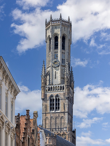 Bruges, Belgium - May 19, 2023: 13th century medieval  tower Belfort (Belfry). This clock tower is one of the recognizable symbols of the city