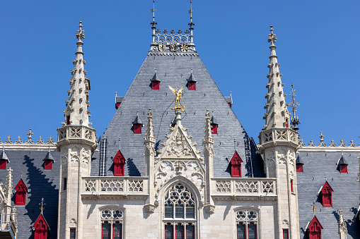 Bruges, Belgium - May 19, 2023: Medieval building of Provincial Court on the Grote Markt, main square in the city. It is the former meeting place for the Provincial Government of West Flanders