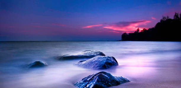 Colorful sunset long exposure shot from La Digue with view to Praslin in the Seychelles.