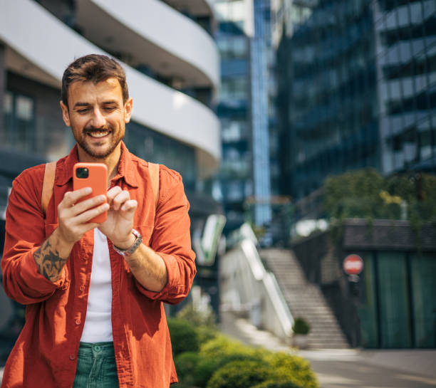 istock A relaxed adult man is coming back from work, he is walking, using the phone. 2148955934