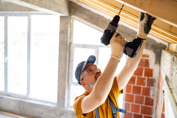 istock Skilled construction worker drilling into a wooden beam at a building site 2148956358