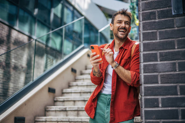 istock A man is standing on the stairs and using the phone. 2148957401