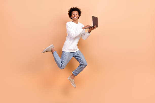 istock Full length photo of cheerful positive man it specialist software developer hold netbook device isolated on beige color background 2148957930