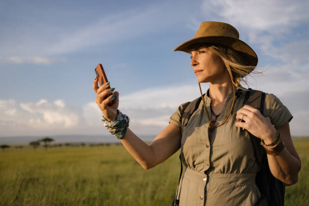 istock Female explorer using mobile phone in national reserve. 2148958030
