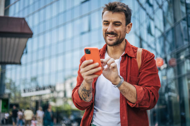 istock A relaxed man is walking down the street and using a smartphone. 2148958300