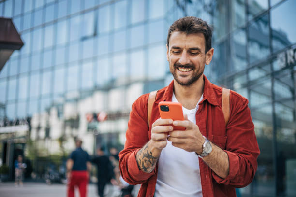 istock A relaxed man is walking down the street and using a smartphone. 2148958393