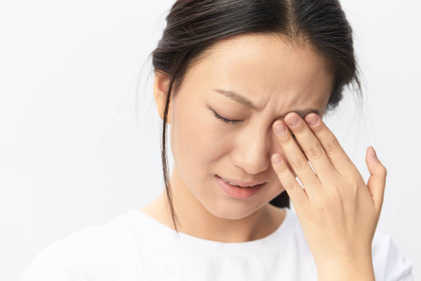 istock Suffering From Strong Pain. Eyesight problem. Tormented suffering tanned beautiful young Asian woman touching eyes posing isolated on white background. Injuries Poor health Illness concept. Cool offer 2148958414